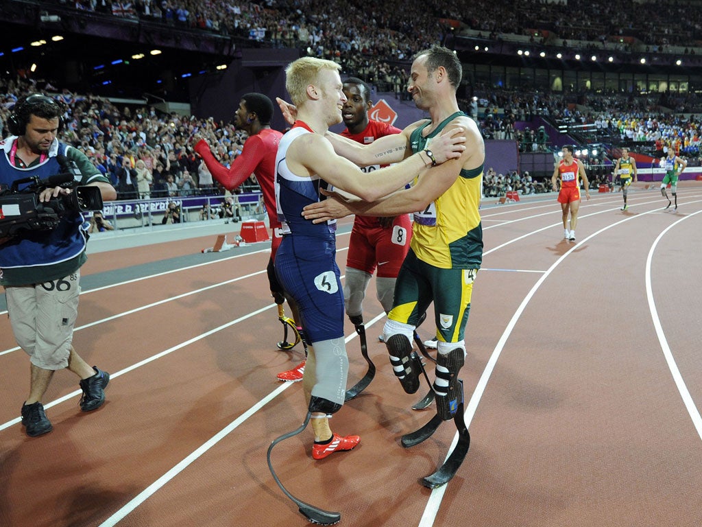 Jonnie Peacock gets a hug from Oscar Pistorius after last night's final