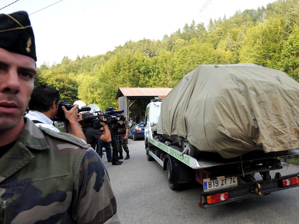 The family's car is transported from the crime scene near Chevaline yesterday