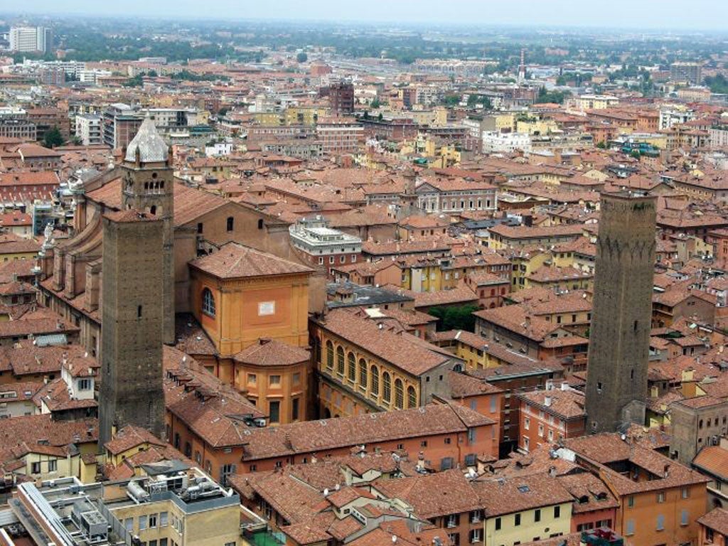 On the tiles: the red roofs and towers of Bologna