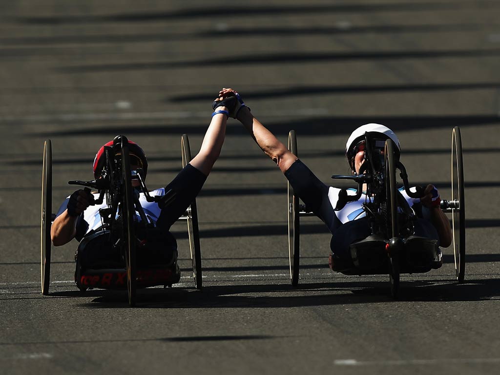 Rachel Morris and Karen Darke cross the finishing line holding hands. Rachel Morris was awarded the bronze medal