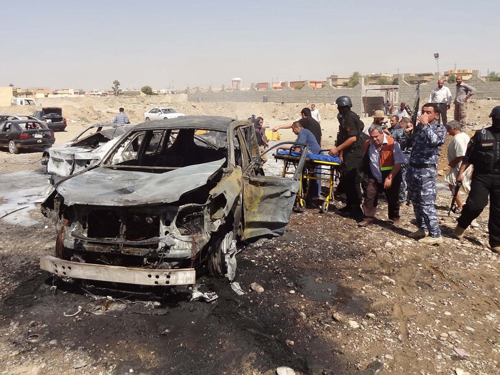 Iraqi security forces and rescue workers inspect the site of the blast in the northern Iraqi city of Kirkuk