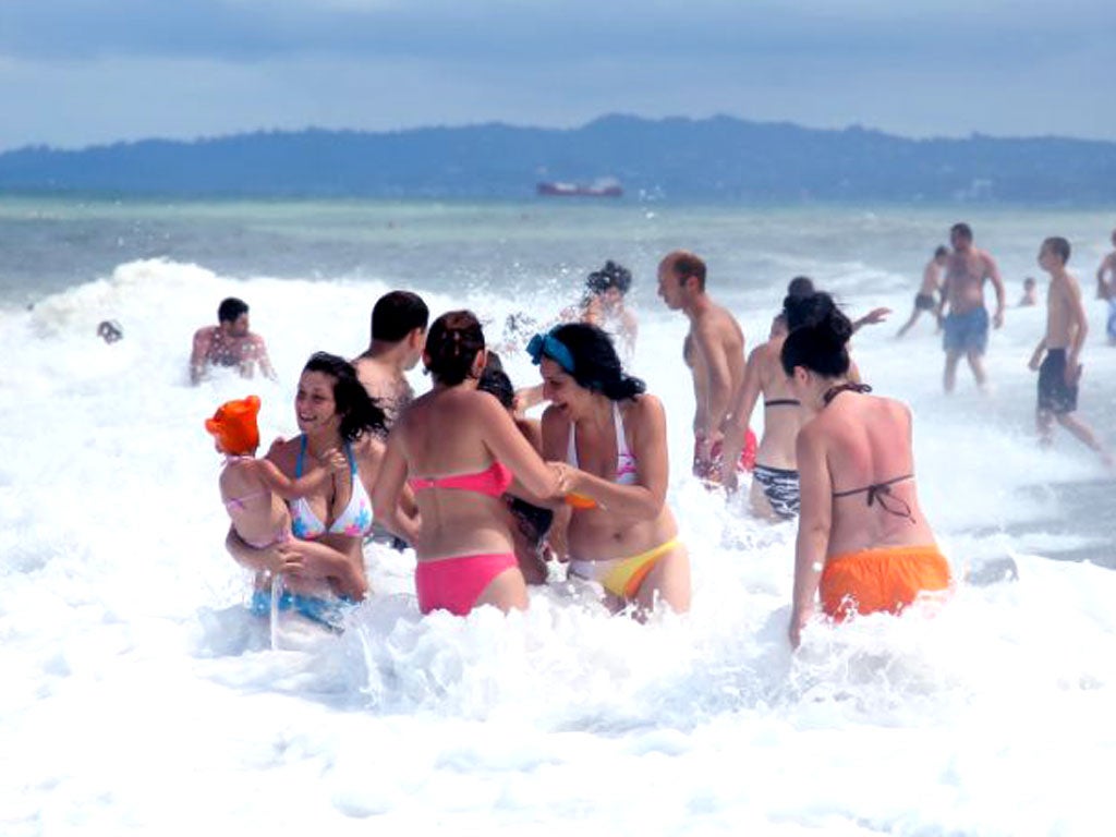 On the beach in Batumi, the Georgian resort, below left, attracted 1.3 million visitors last year