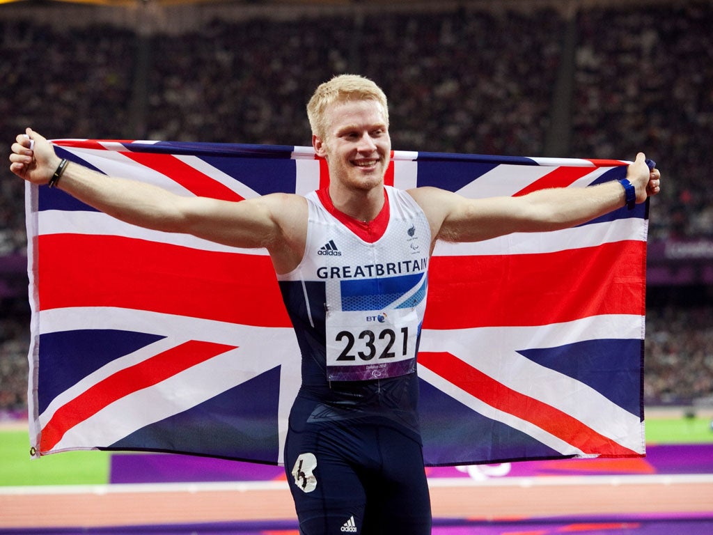 Proud Peacock: Jonnie on his lap of honour after winning the T44 100m