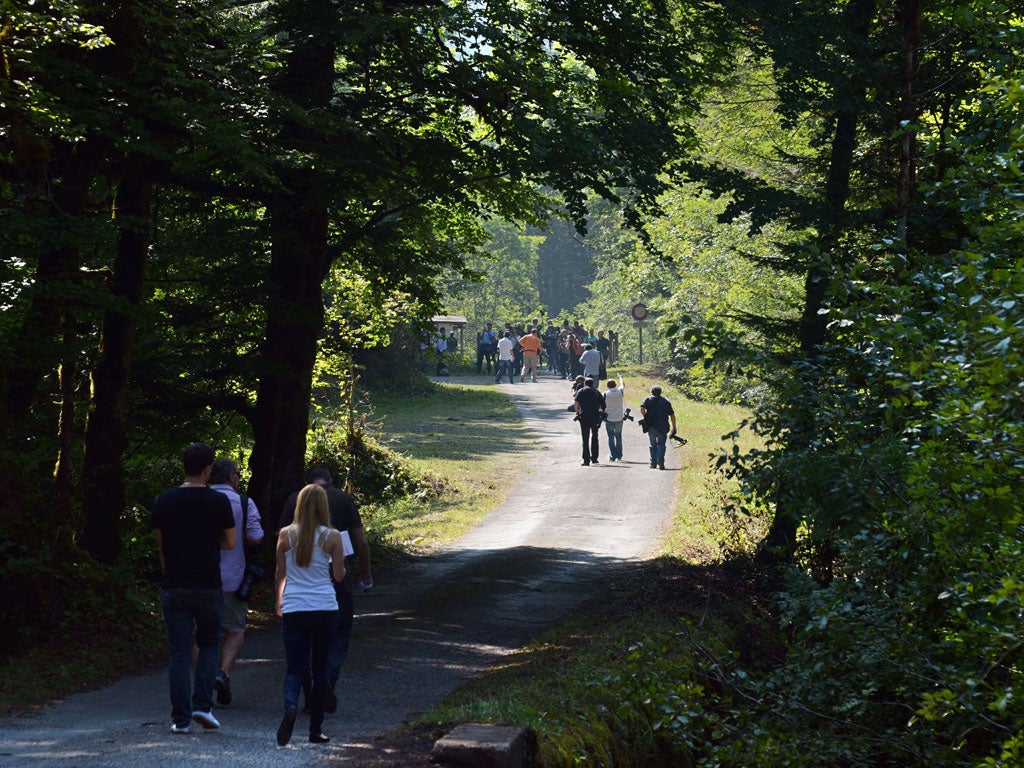 Journalists investigating the scene of the crime on the Combe de l'Ire