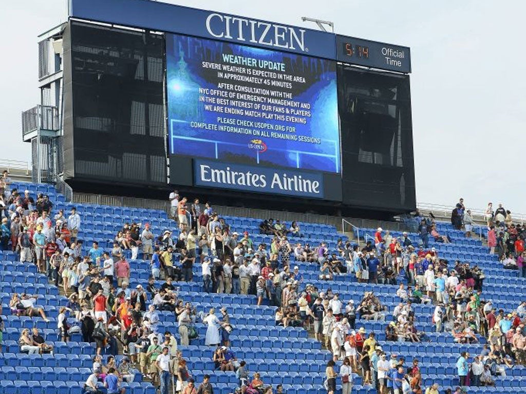 The scoreboard shows a weather warning as fans head to the exits on Saturday