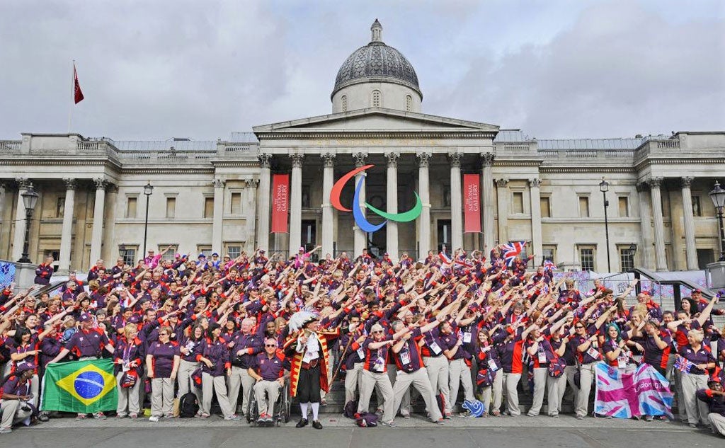 Olympic volunteers pose in front of the National Gallery before the victory parade