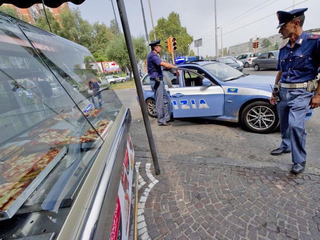 Police guard a bar where mobster Raffaele Abete was shot dead by rivals in the bloody Naples turf wars