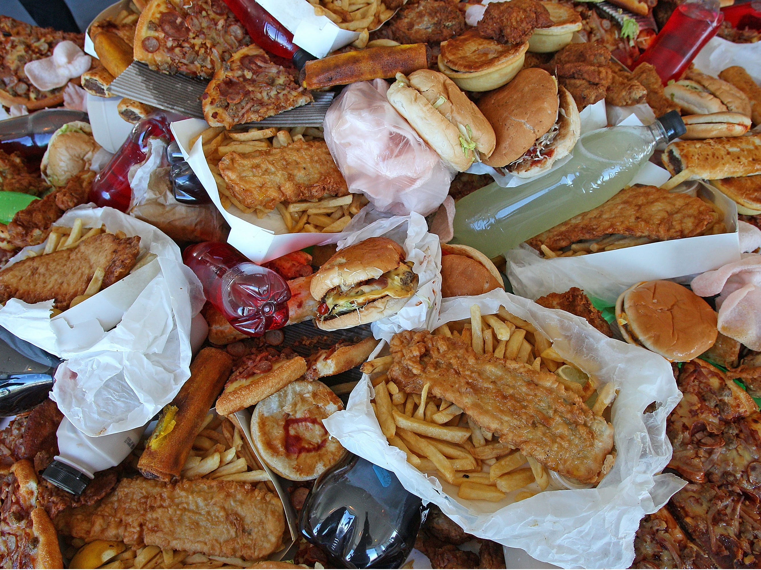 MELBOURNE, AUSTRALIA - MARCH 06: Junk food sits on a table as British Celebrity Chef Jamie Oliver announces a partnership to attack state-wide obesity