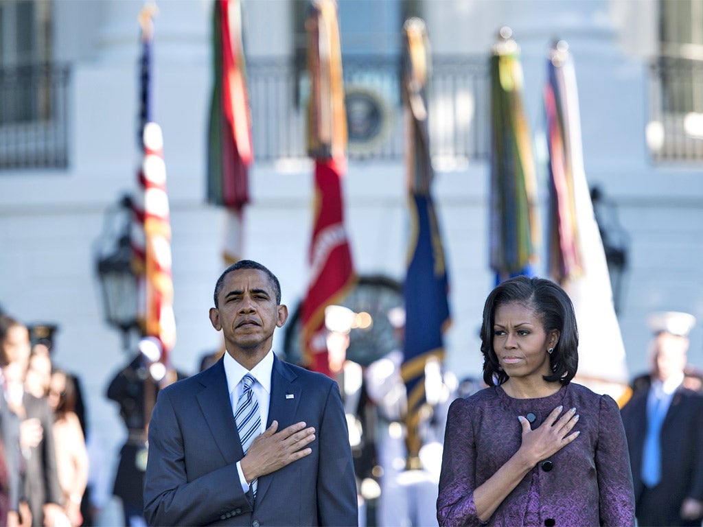 Barack and Michelle Obama during a moment of silence to mark the 11th anniversary of 9/11 at the White House yesterday