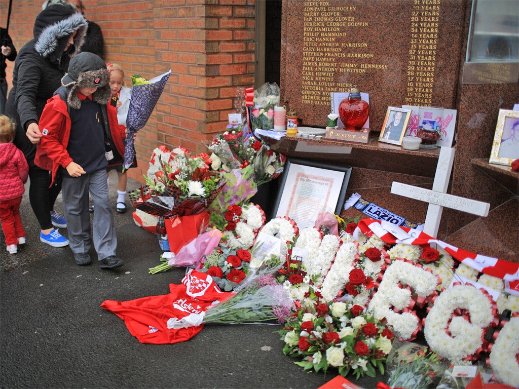 Children lay tributes to the Hillsborough disaster victims at Anfield