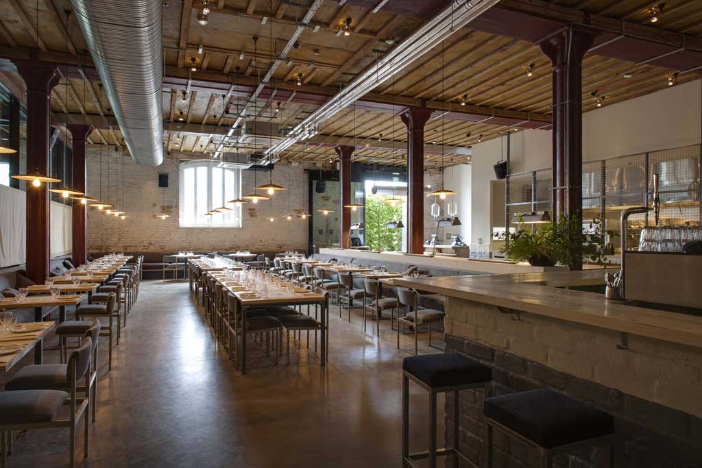 Warehouse-chic with a touch of class: Caravan is all high wooden beams and low-hanging lights