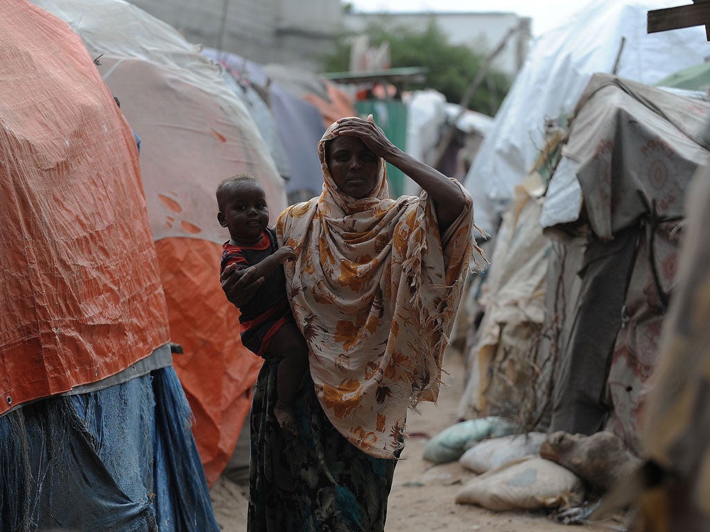 Aisha Omar Ahmed returned to Somalia, her homeland, to help salvage the wreckage on the front line. She trains birth attendants and helping internally displaced people like this woman with her baby in Mogadishu