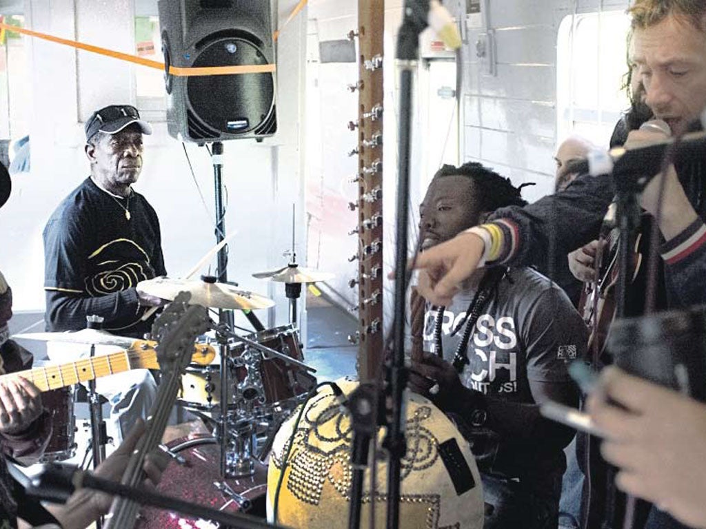 Do the locomotion: Tony Allen (drums), Diabel Cissokho (kora) and Damon Albarn (microphone) practising on the train