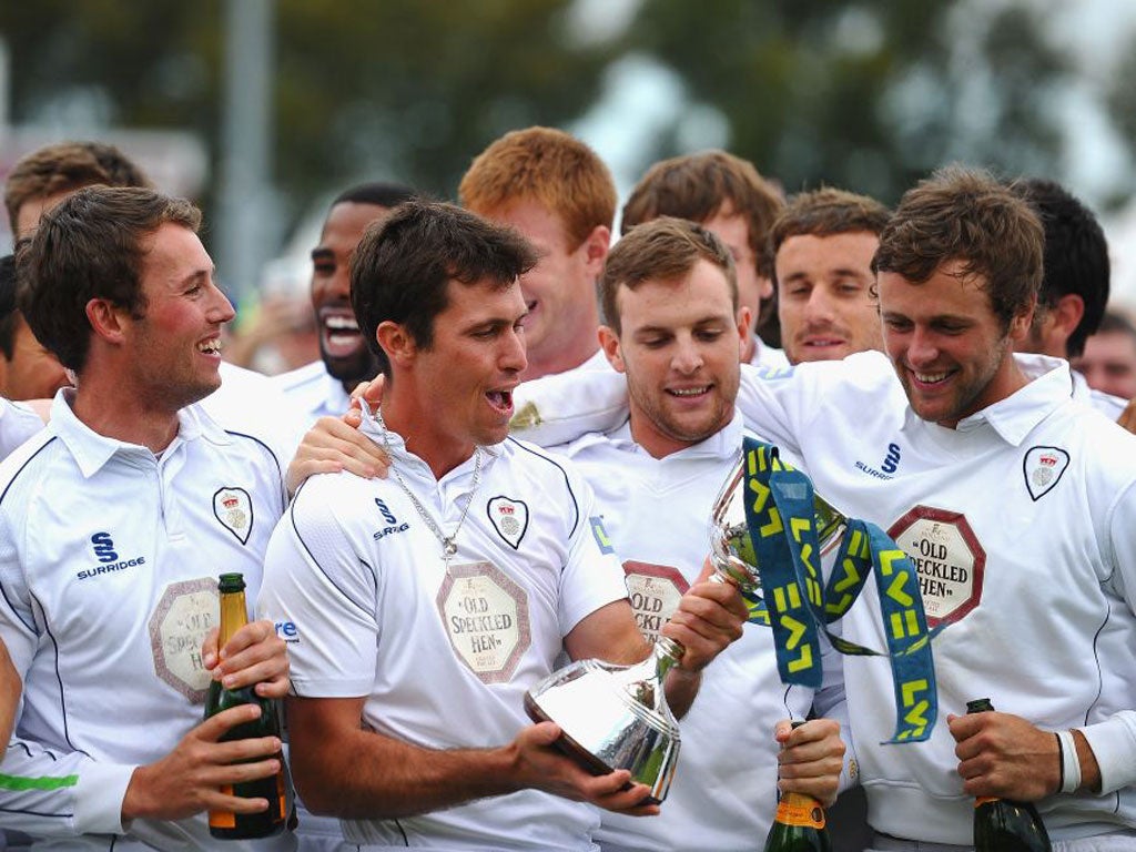 Captain Wayne Madsen and his Derbyshire team-mates get their hands on the Second Division trophy