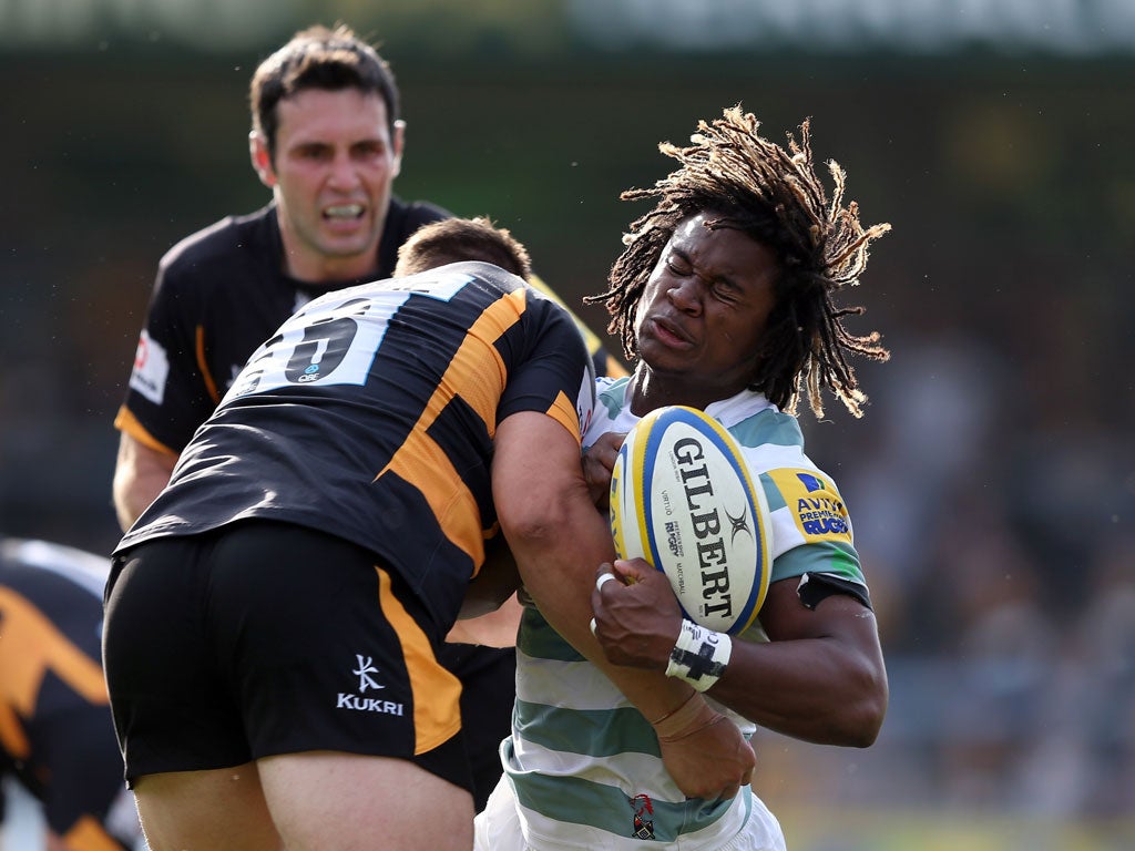 Big hitter: Marlan Yarde of London Irish feels the weight of Wasp Tom Lindsay's challenge at Adams Park