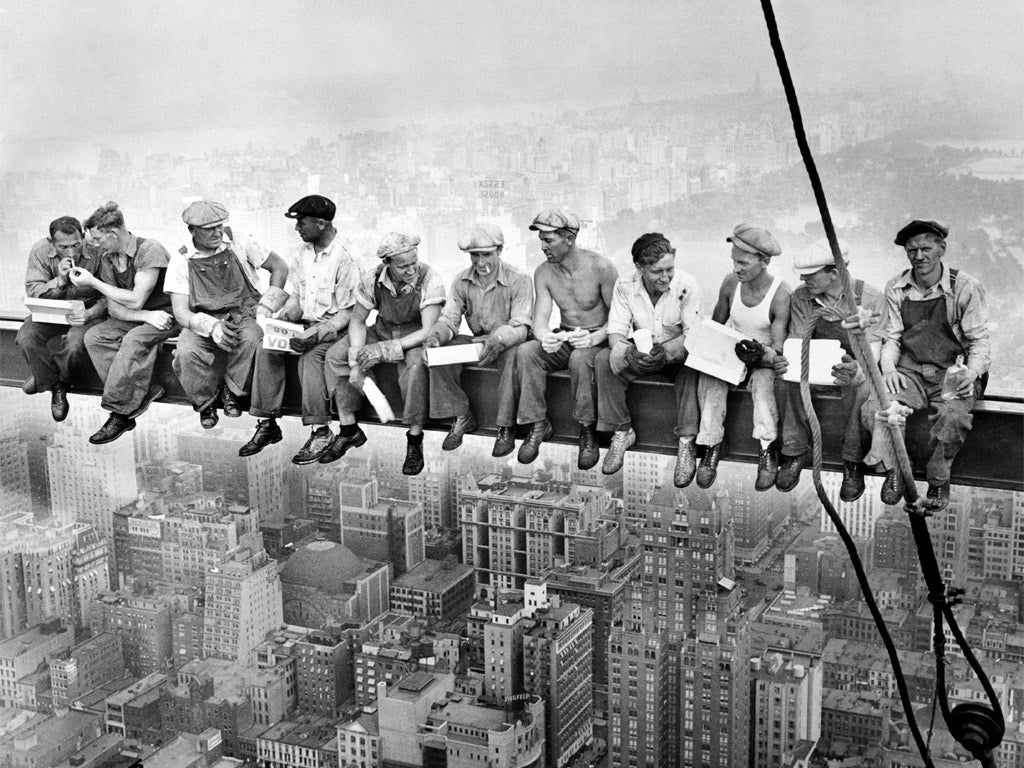 The 11 men sit eating lunch high above New York