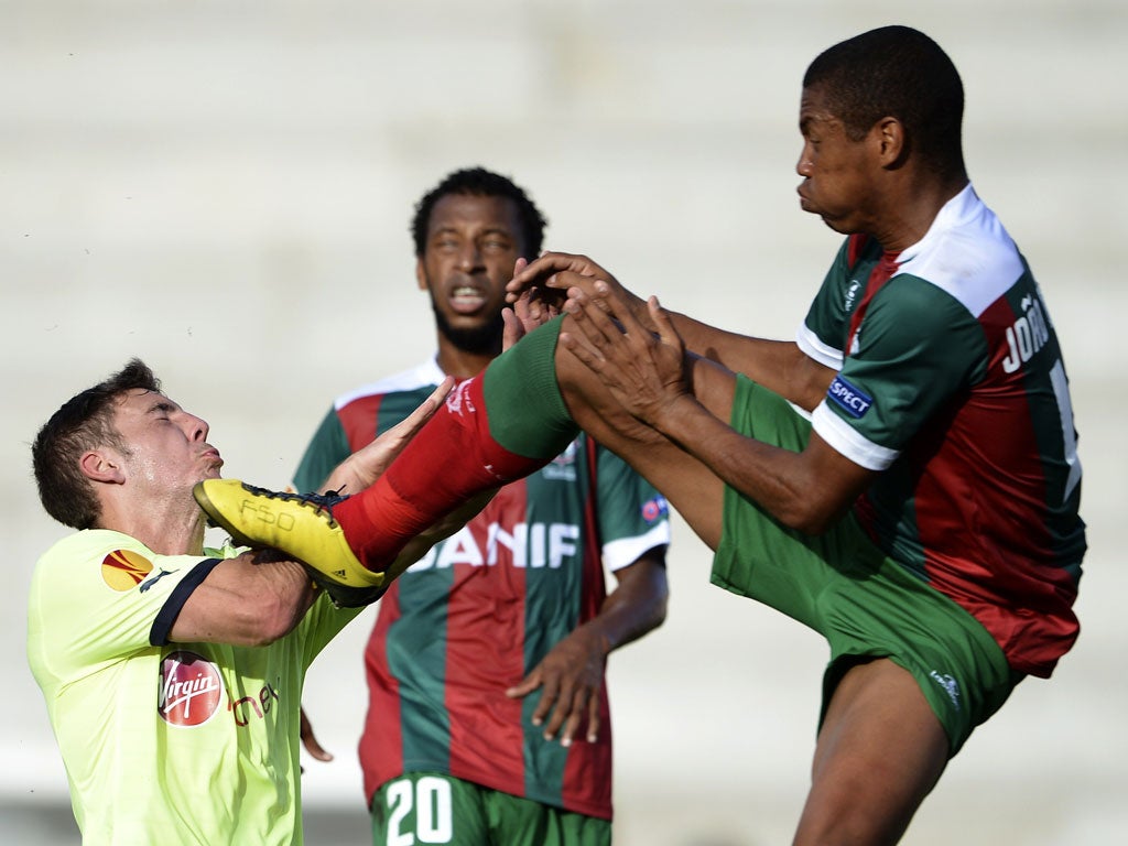 Newcastle's midfielder Dan Gosling clashes with Maritimo's defender Joao Guilherme