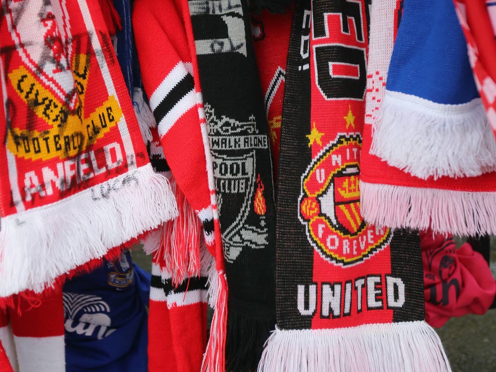 Manchester United and Liverpool scarfs hang side-by-side in tribute to those who died at Hillsborough