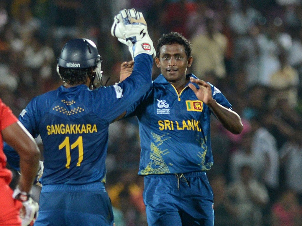 Star turn: Ajantha Mendis (right) celebrates his brilliant 6 for 8