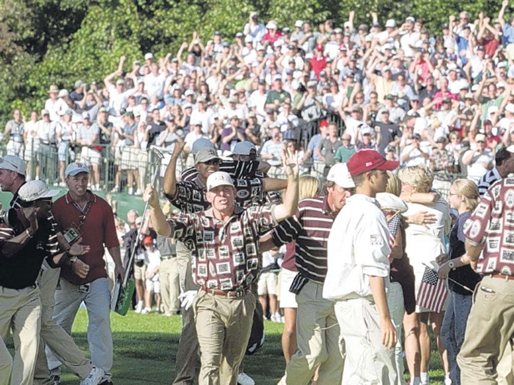 Jason Leonard tries to clear US team-mates and fans from the
green at Brookline in 1999