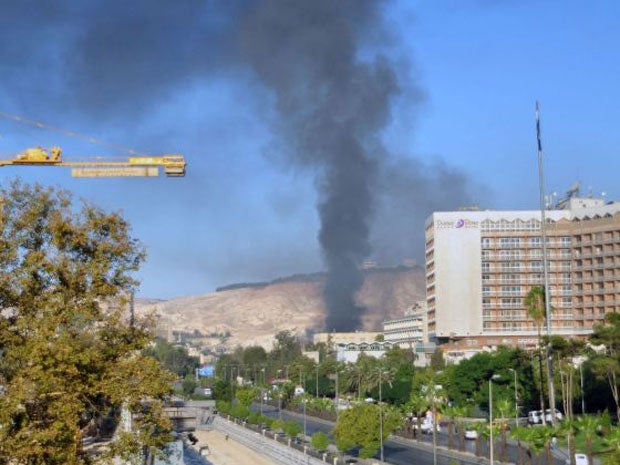 Columns of smoke rise from the site that has been hit by two powerful explosions in Damascus