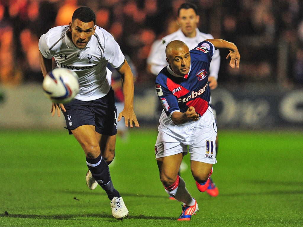 Tottenham's Steven Caulker tussles with Carlisle striker Danny Cadamarter