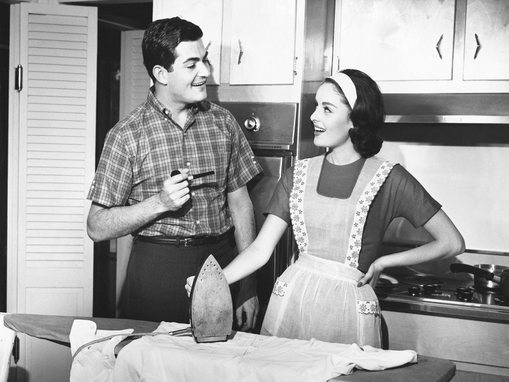 UNITED STATES - CIRCA 1950s: Couple ironing.