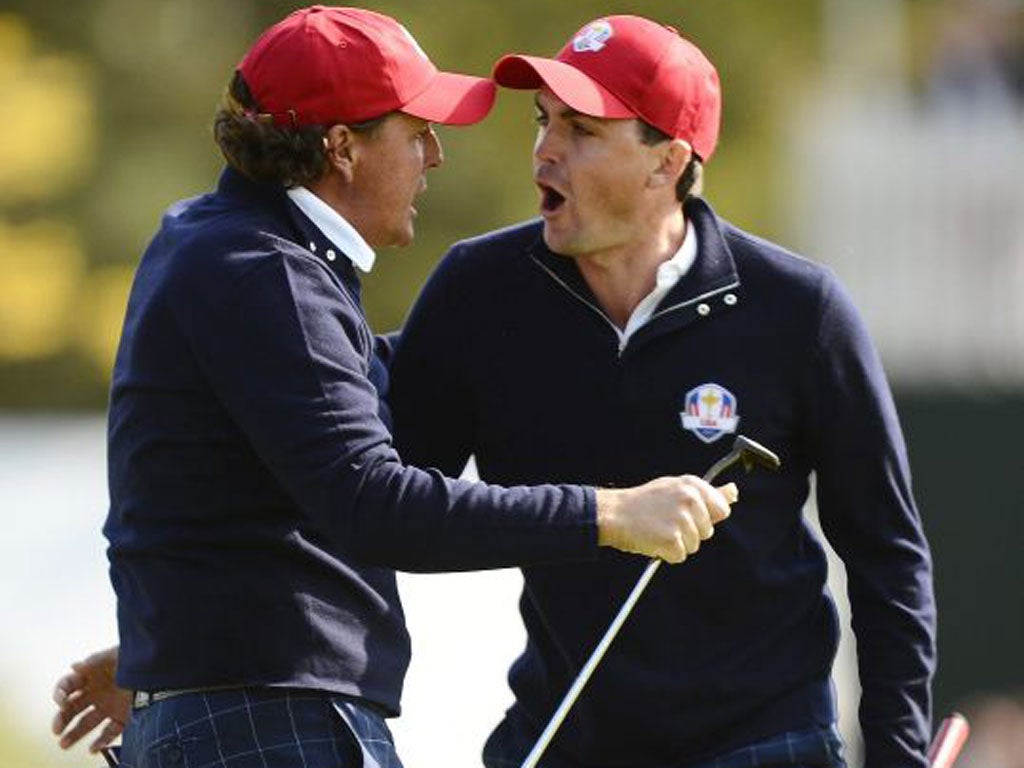 Phil Mickelson (left) and Keegan Bradley celebrate after the latter’s winning putt on the 15th hole