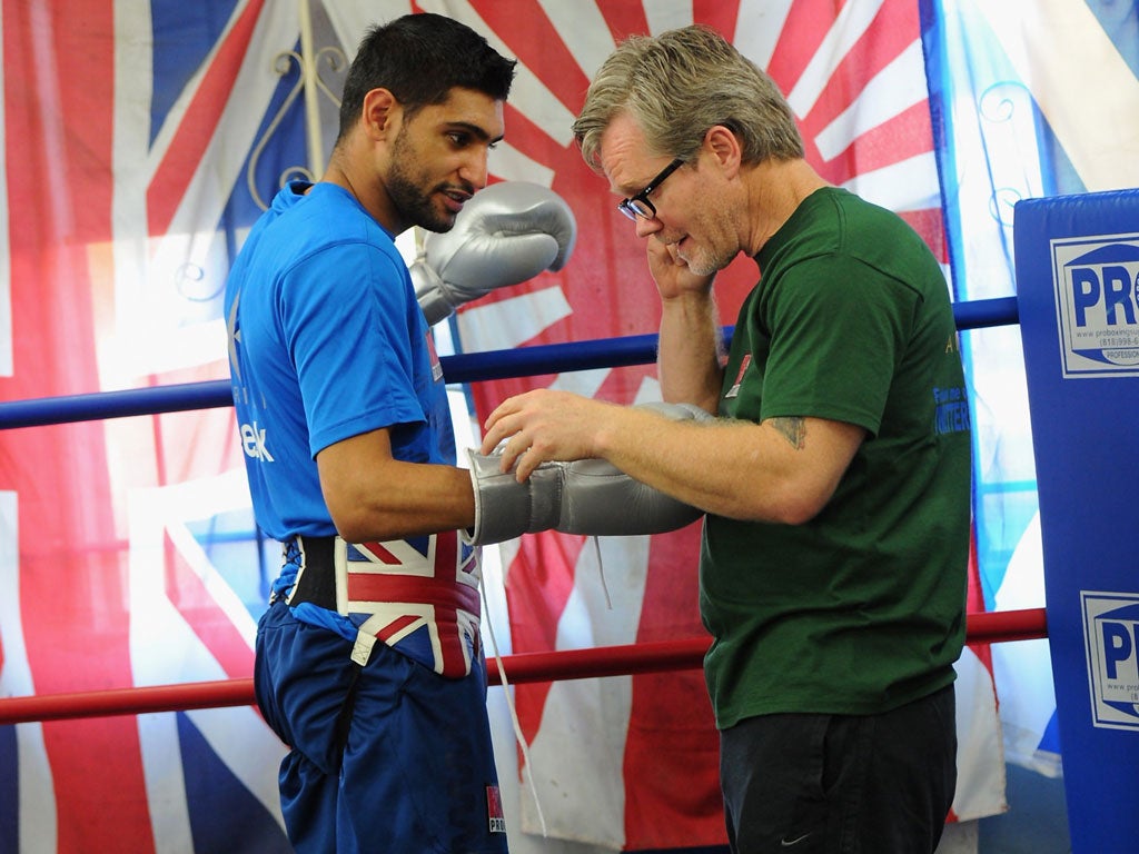 Glory hunter: Amir Khan has left Freddie Roach (right) for Virgil Hunter