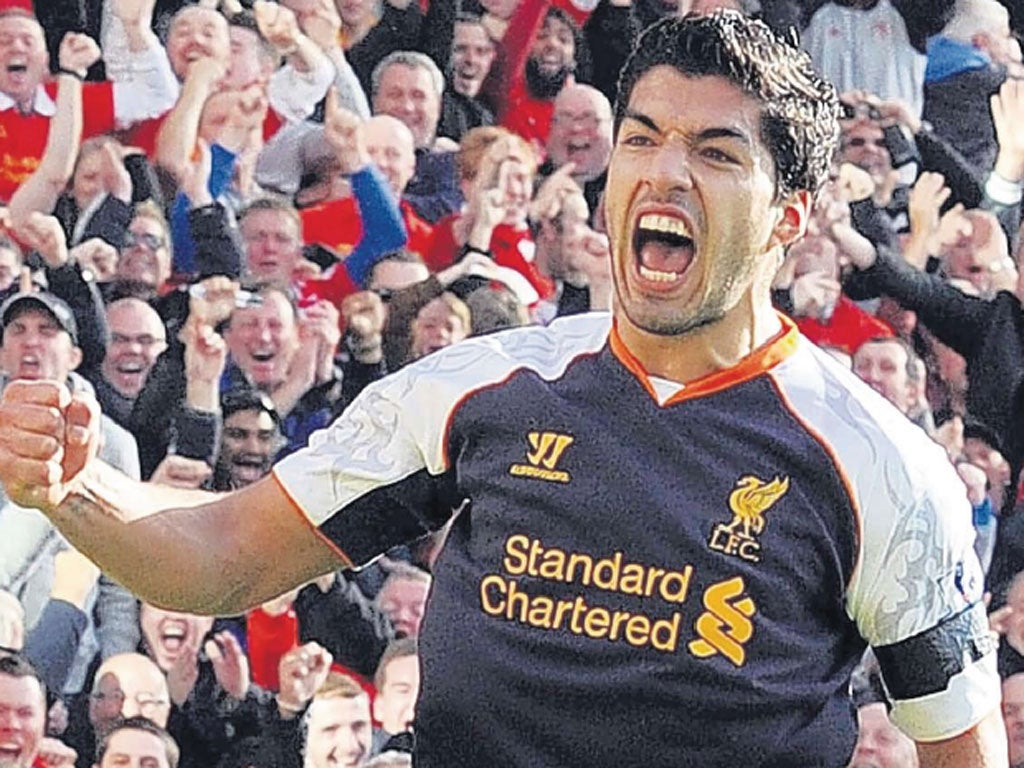 Luis Suarez celebrates after scoring his second goal against Norwich