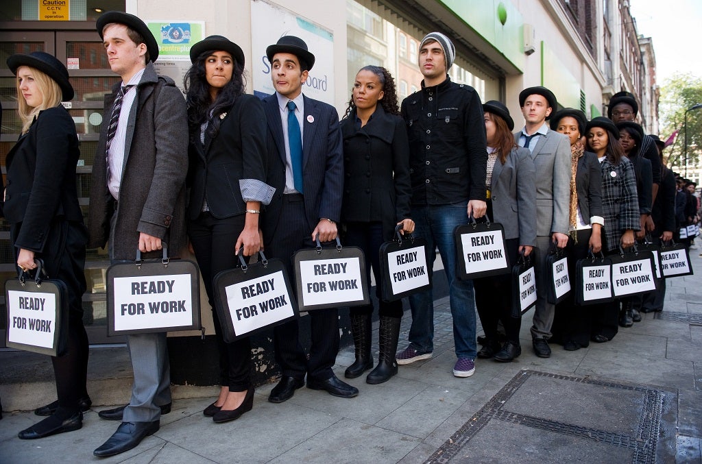 British musicians Miss Dynamite (5th L) and Charlie Simpson (6th L) join unemployed young people as they stand in line outside a job centre in central London