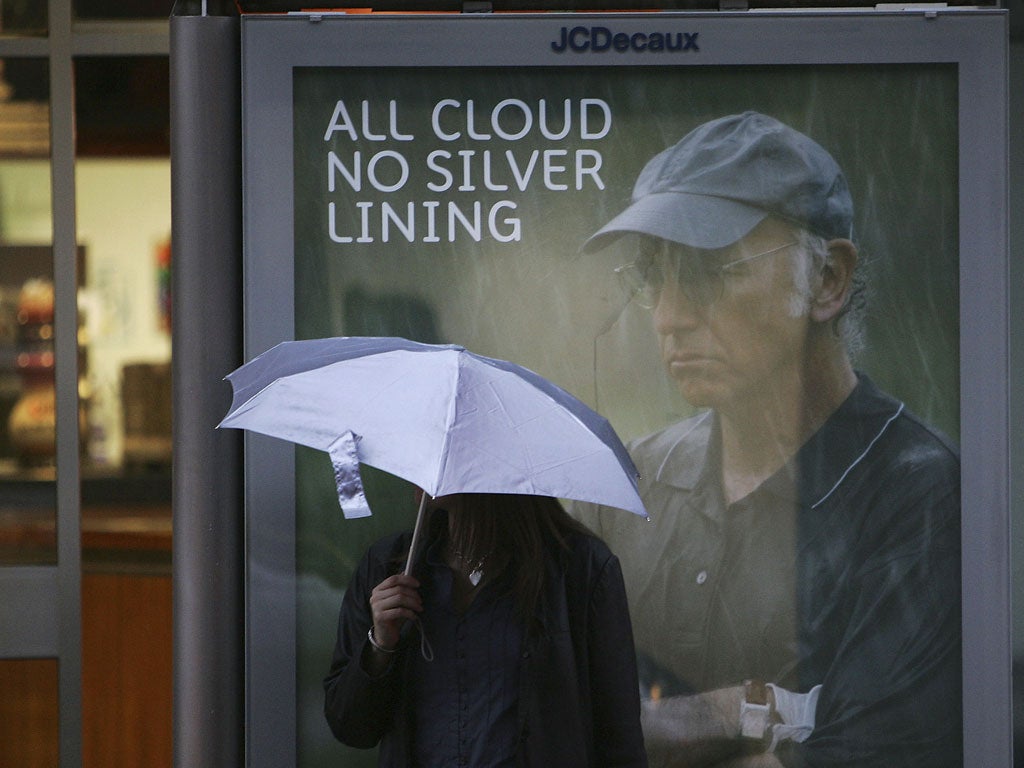 A woman waits for bus on her way home from work on October 10, 2005 in Glasgow, Scotland.