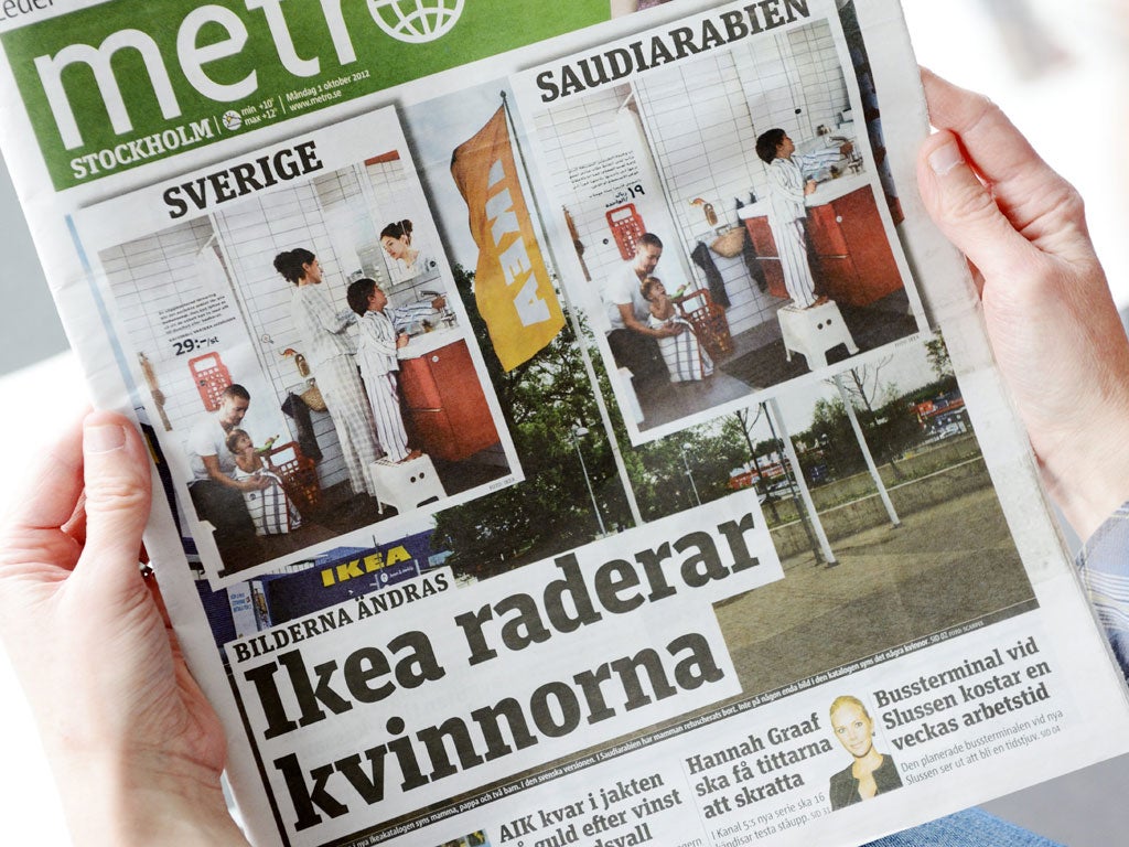 A person holds in Stockholm the October 1, 2012 issue of the free daily Metro newspaper, featuring two versions of the same photo from Swedish furniture giant Ikea's yearly catalogue