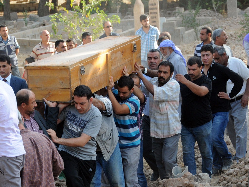 Mourners carry the coffin of one of the five civilians killed in Akcakale