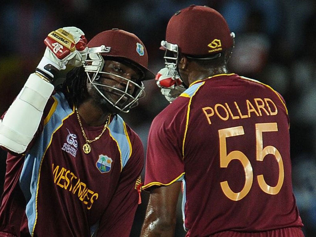 Chris Gayle celebrates with Kieron Pollard