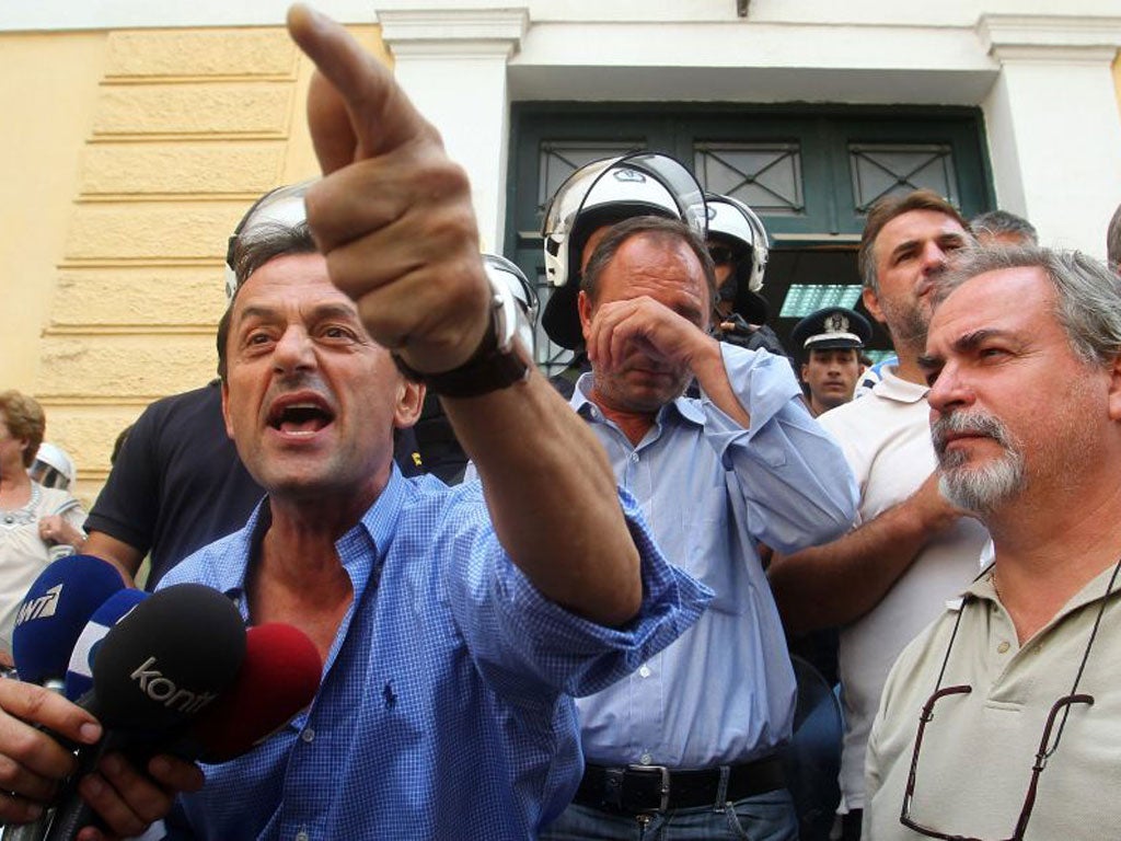 Greek shipyard workers, who stormed the defence ministry in protest at austerity measures and job cuts, emerge from a court yesterday after charges were filed against them