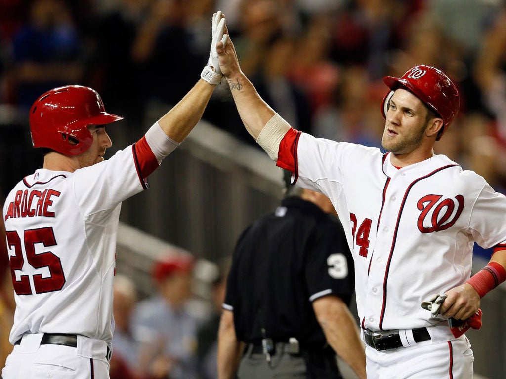 Sluggers Adam LaRoche (left) and Bryce Harper celebrate a score for the Washington Nationals