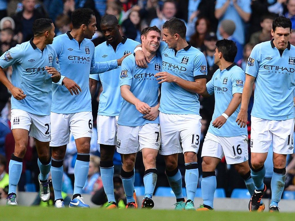 Man City 3-0 Sunderland James Milner (4th L) celebrates with fellow goal-scorer Serbian defender Aleksandar Kolarov (3rd R) after scoring his side's third goal.