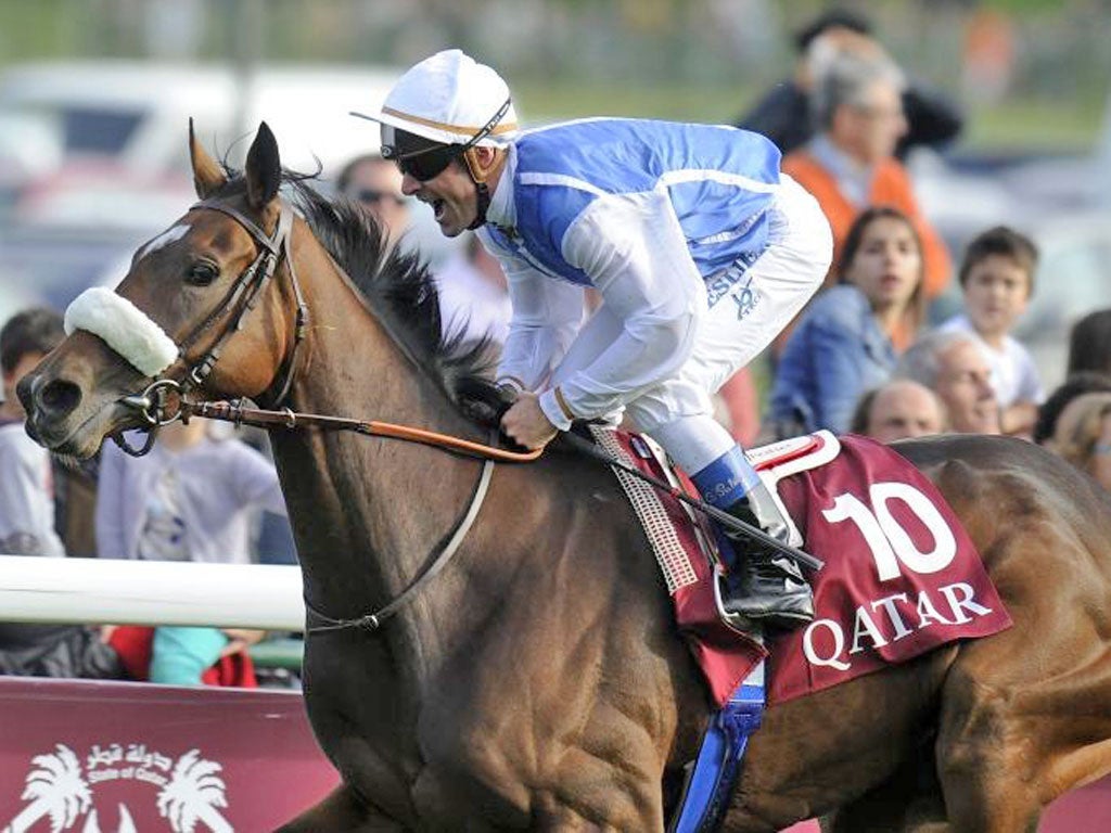 Olivier Peslier celebrates winning by a neck on Solemia