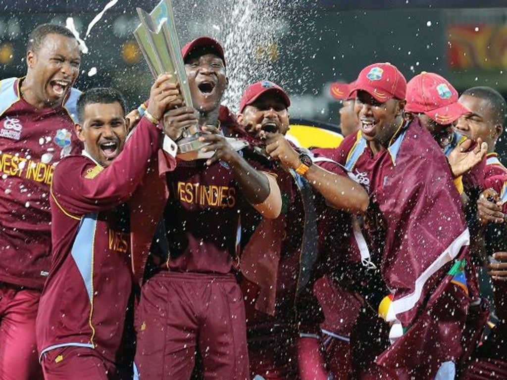 West Indies team celebrates with the trophy on the podium after winning the final of the World Twenty20 tournament