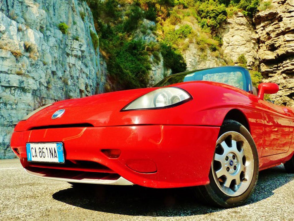 A scarlet, convertible Fiat Barchetta