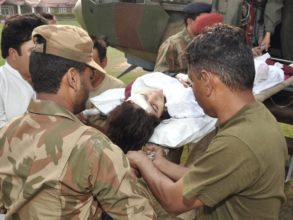 Pakistani soldiers shift injured Malala Yousafzai from a helicopter at an army hospital following an attack by gunmen in Peshawar