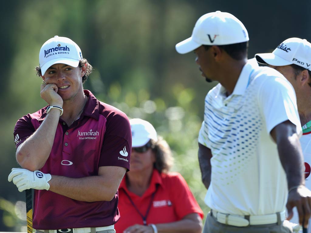 Rory McIlroy and Tiger Woods pictured competing this morning