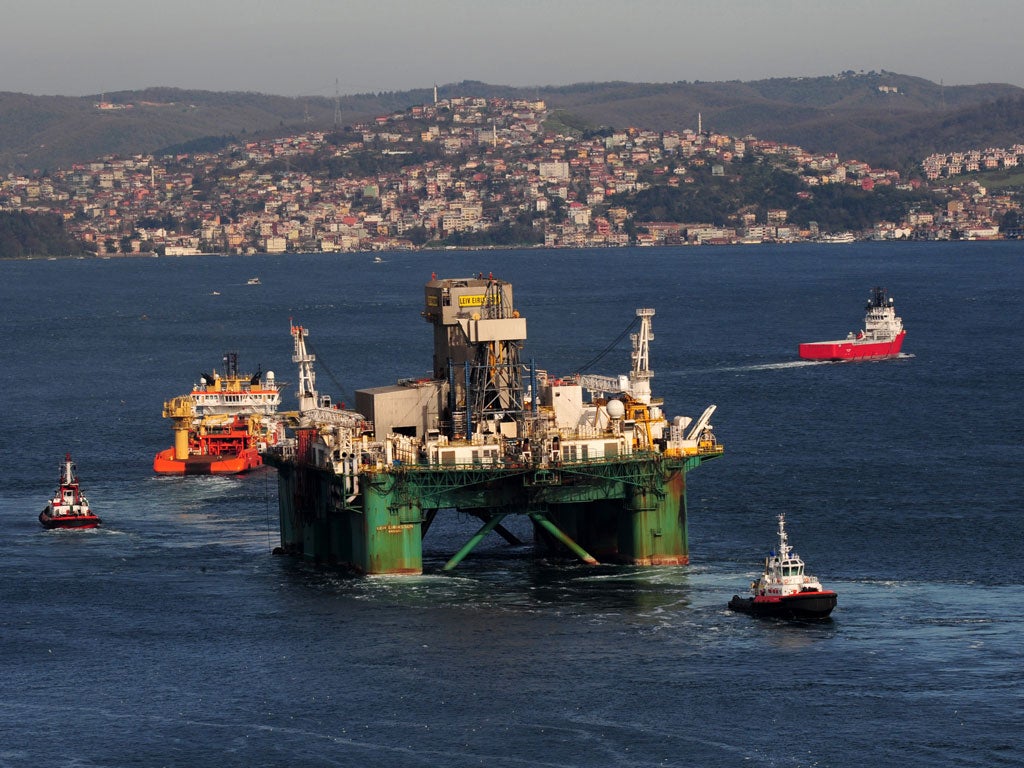 The Leiv Eiriksson, one of the world's largest oil drilling platform, is escorted by tugboats as it leaves the Bosphorus in Istanbul, on December 31, 2009