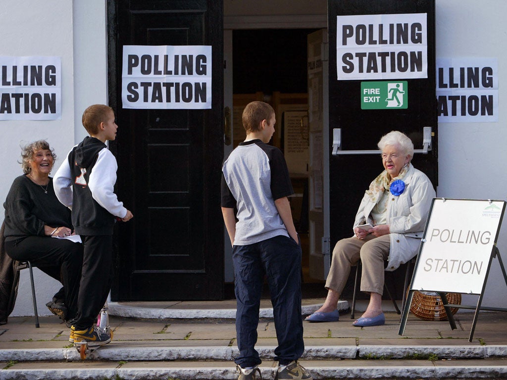 Teenagers make a request to vote at a polling station in Stanwell Village, west of London 05 May 2005.