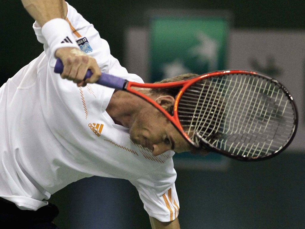 Andy Murray smashes his racket after his opponent broke back