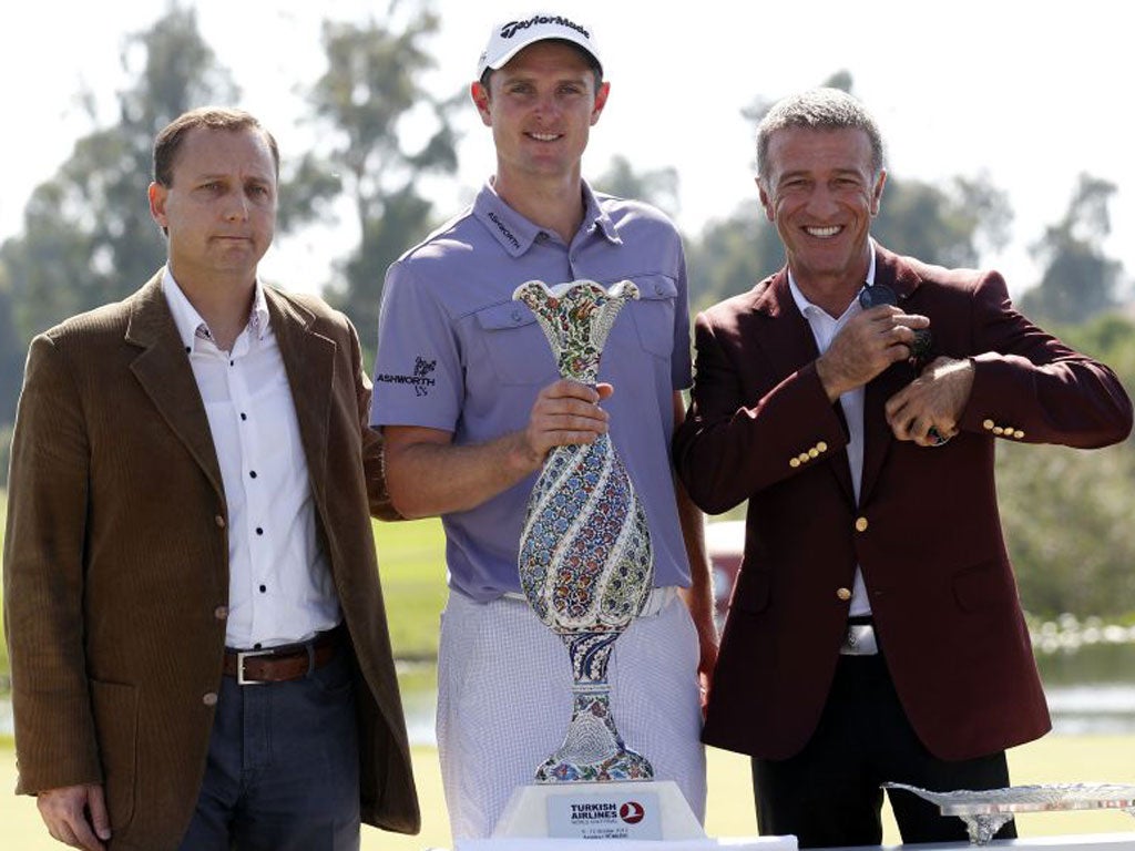 Justin Rose with the President of Turkish Golf Ahmet Agaoglu after beating Lee Westwood to win the World Golf Final yesterday