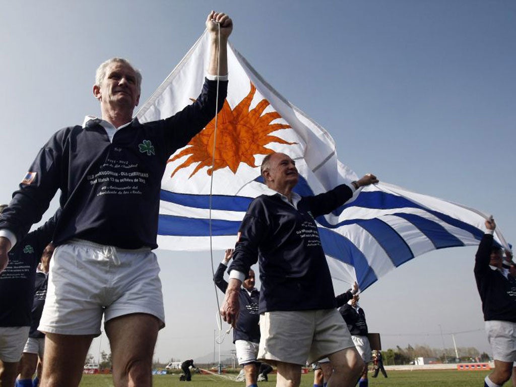 Survivors of the Andean plane tragedy, below, fly the Uruguayan flag before the game