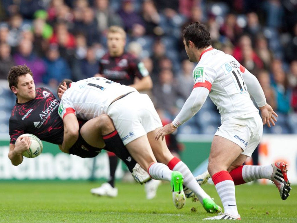 Edinburgh’s Nick De Luca is tackled by Saracens’ Joel Tomkins