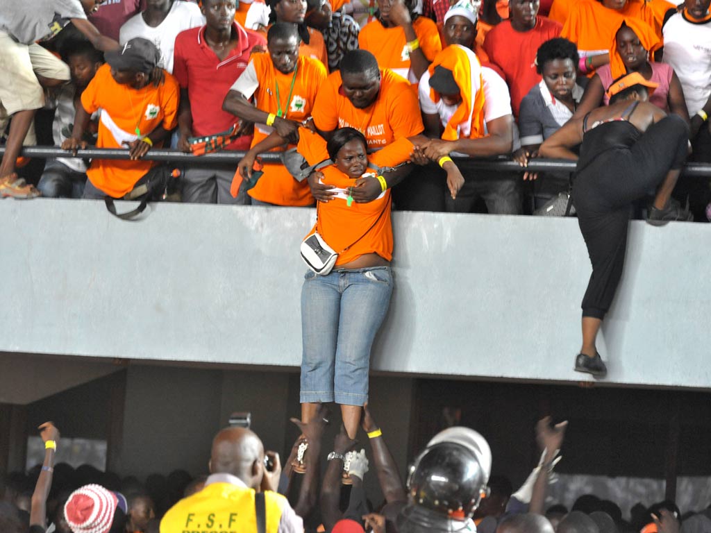 Ivory Coast fans look to flee the stands